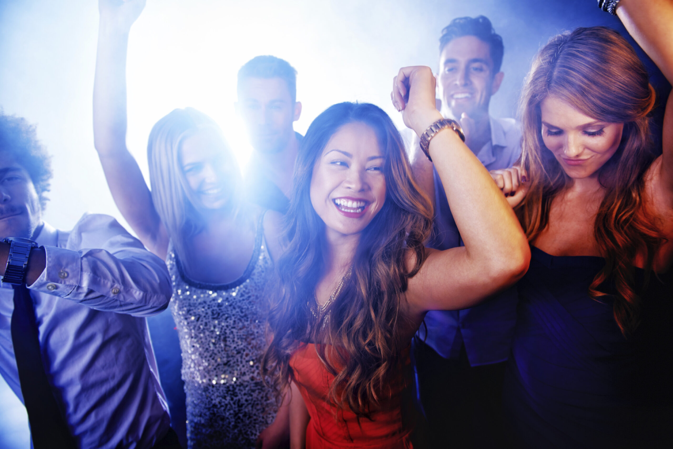 A group of young people dancing in a club